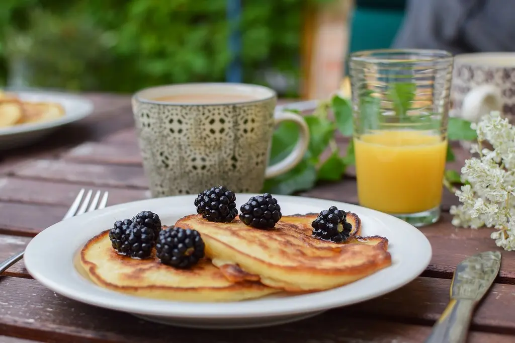 Blackberry pancakes brunch spread with coffee and orange juice